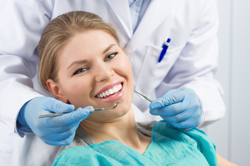 Close-up of happy smiling dental care woman visiting dentist
